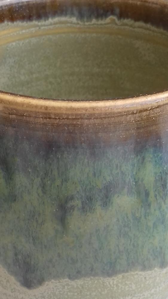 Close-up of overlapped glazed mug