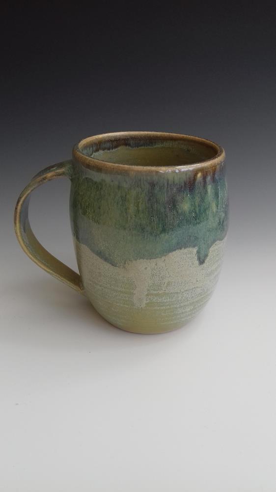 Stoneware mug,
Green glazes overlapped.
